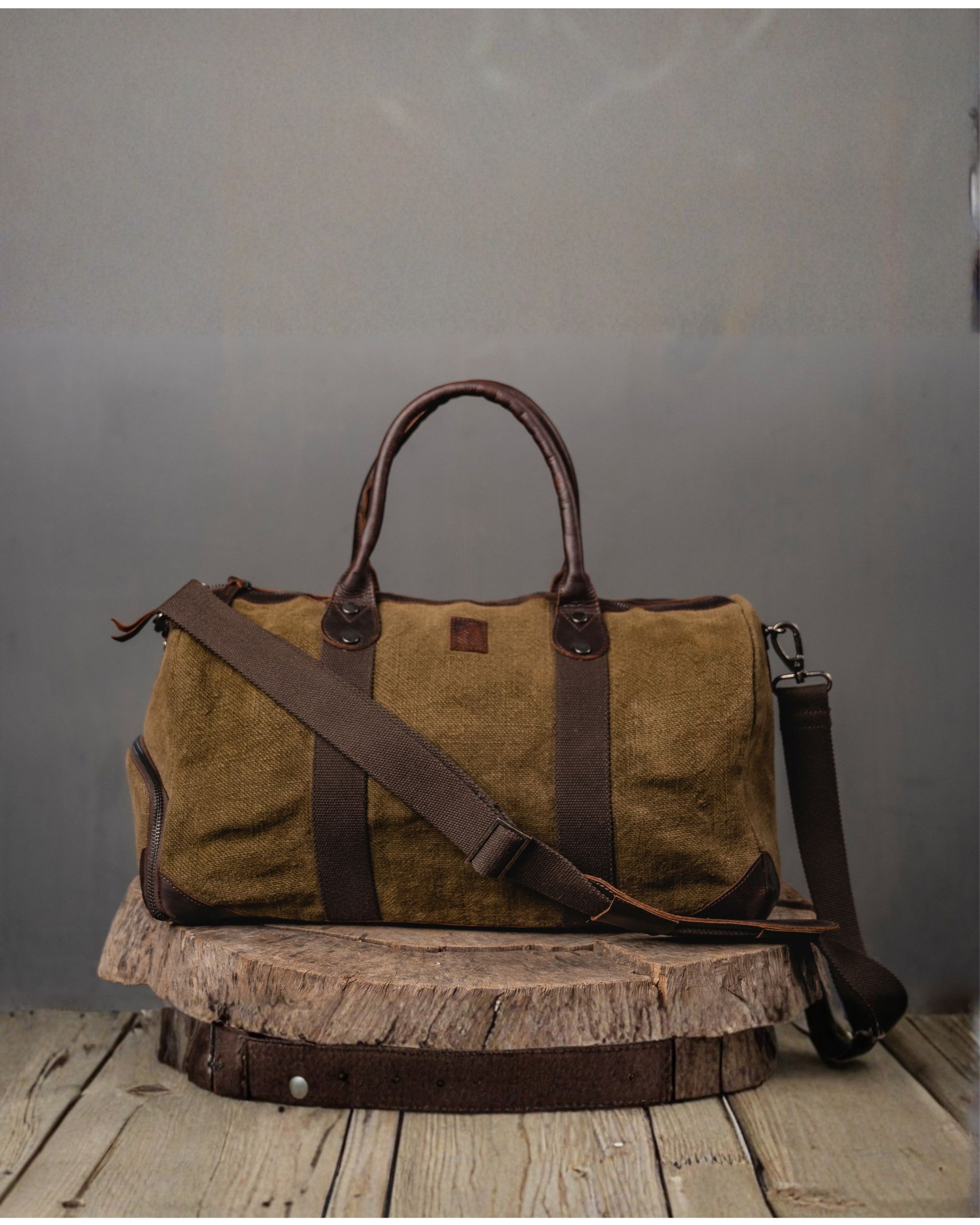 Brown Duffel 2.0 Mini front view in heavyweight burlap canvas showing detachable shoulder strap, side zip compartment, leather trim and antique brass fittings